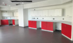 First Floor Rooms Showing Healthcare Furniture With Red Door Fronts At Meridian Surgery